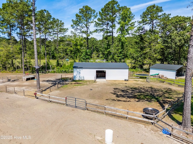 105 Teal Pointe Dr, Pikeville, NC 27863 - view of front of home with an outbuilding, dirt driveway, metal roof, and an exterior structure