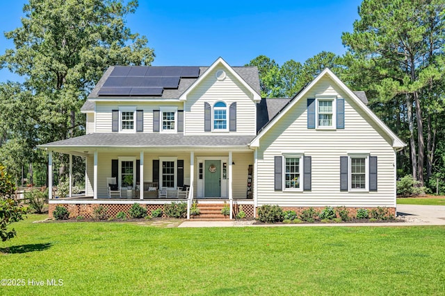 105 Teal Pointe Dr, Pikeville, NC 27863 - view of front of property with a porch, solar panels, a front yard, and roof with shingles