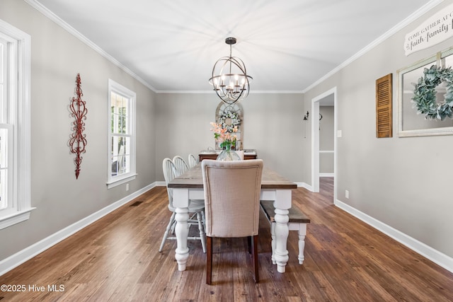 105 Teal Pointe Dr, Pikeville, NC 27863 - dining space with a chandelier, wood finished floors, baseboards, and crown molding