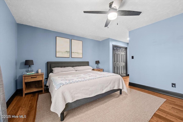 105 Tartan Trl, Southern Pines, NC 28387 - bedroom featuring wood finished floors, a closet, ceiling fan, and a textured ceiling