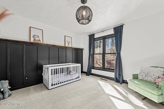 105 Tartan Trl, Southern Pines, NC 28387 - carpeted bedroom featuring a textured ceiling and a crib