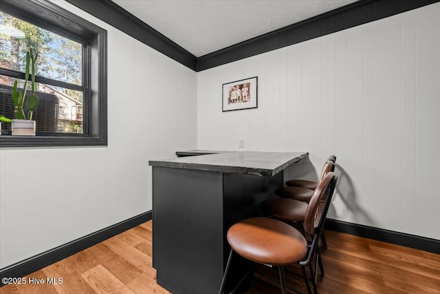 105 Tartan Trl, Southern Pines, NC 28387 - office area with wood finished floors, a bar, crown molding, and a textured ceiling