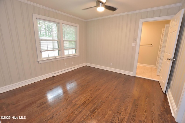 853 Burton St, Rocky Mount, NC 27803 - empty room featuring a baseboard heating unit, dark wood finished floors, a ceiling fan, crown molding, and baseboards