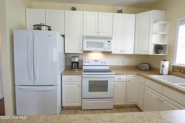 405 27th St Unit A, Sunset Beach, NC 28468 - kitchen featuring white appliances, open shelves, white cabinets, light countertops, and light tile patterned flooring