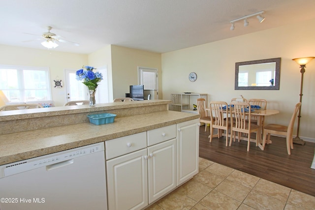 405 27th St Unit A, Sunset Beach, NC 28468 - kitchen featuring white dishwasher, a ceiling fan, light tile patterned floors, white cabinetry, and light countertops