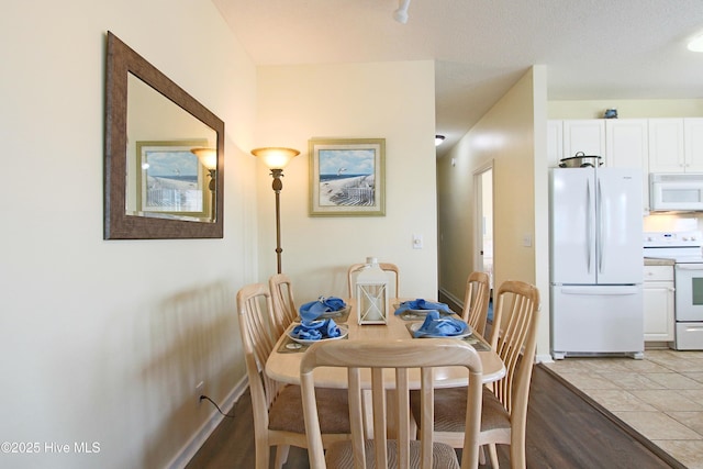 405 27th St Unit A, Sunset Beach, NC 28468 - dining space featuring light wood finished floors and baseboards