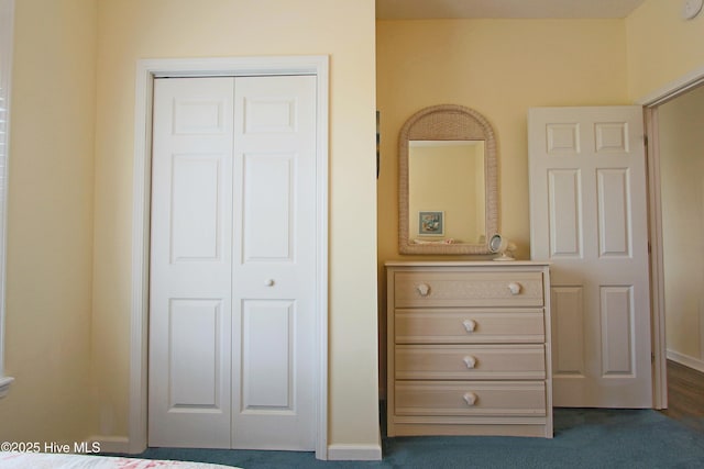 405 27th St Unit A, Sunset Beach, NC 28468 - bedroom featuring a closet, dark colored carpet, and baseboards
