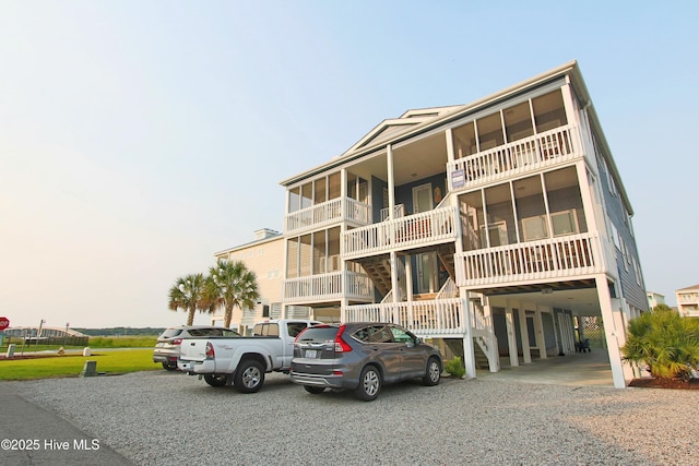 405 27th St Unit A, Sunset Beach, NC 28468 - view of property featuring a carport and gravel driveway