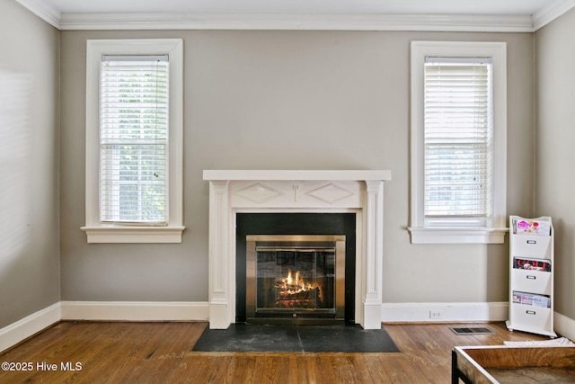 1305 Kenan St NW, Wilson, NC 27893 - detailed view of a fireplace with flush hearth, wood finished floors, ornamental molding, and baseboards