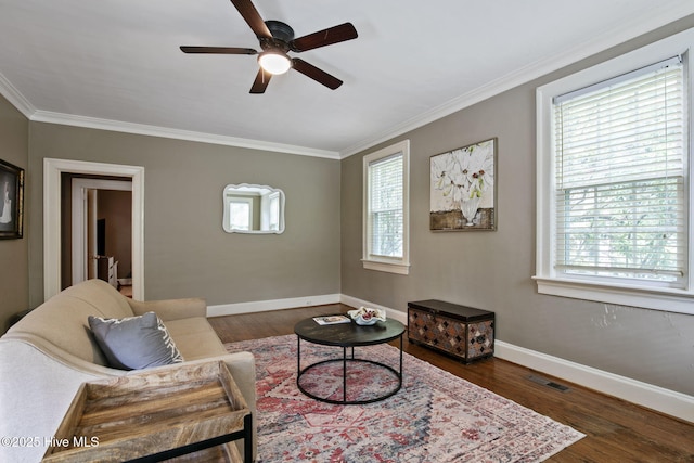 1305 Kenan St NW, Wilson, NC 27893 - living area featuring a ceiling fan, healthy amount of natural light, ornamental molding, dark wood-style flooring, and baseboards