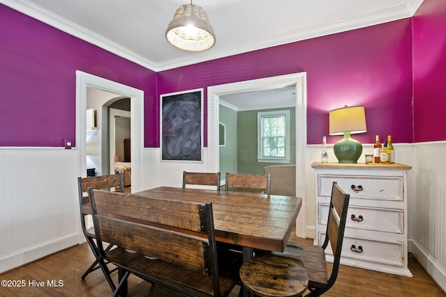 1305 Kenan St NW, Wilson, NC 27893 - dining room featuring wainscoting, ornamental molding, wood finished floors, and arched walkways