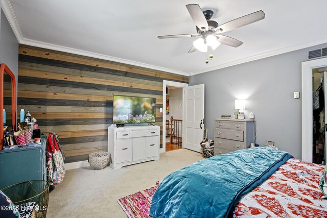 1305 Kenan St NW, Wilson, NC 27893 - carpeted bedroom with ornamental molding, wood walls, and a ceiling fan