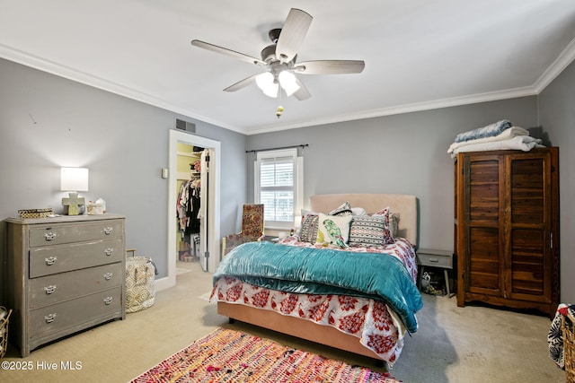 1305 Kenan St NW, Wilson, NC 27893 - carpeted bedroom featuring ornamental molding, a spacious closet, a closet, and a ceiling fan
