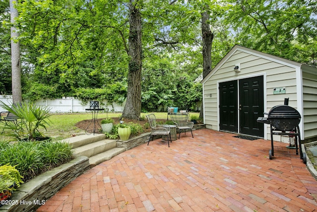 1305 Kenan St NW, Wilson, NC 27893 - view of patio / terrace with an outdoor structure, area for grilling, and view of wooded area