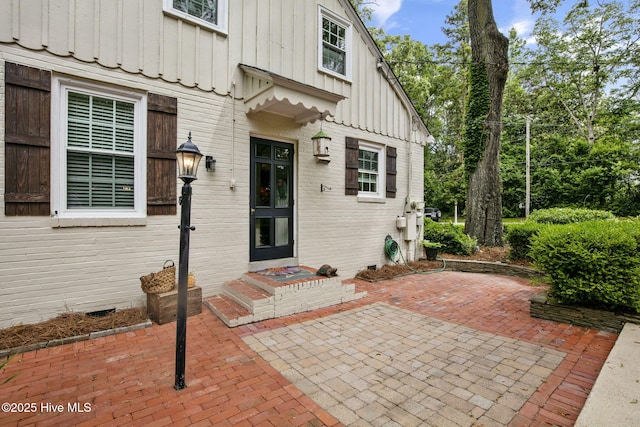1305 Kenan St NW, Wilson, NC 27893 - view of exterior entry featuring board and batten siding and a patio