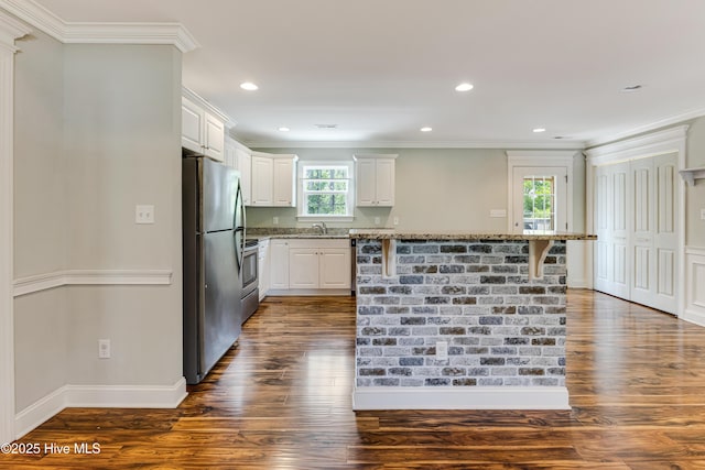 1711 Reidsville Rd, Southport, NC 28461 - kitchen featuring appliances with stainless steel finishes, a sink, dark wood finished floors, light stone countertops, and ornamental molding
