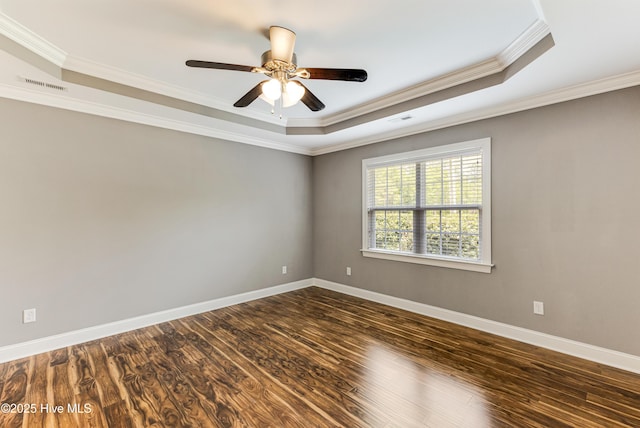 1711 Reidsville Rd, Southport, NC 28461 - spare room with a raised ceiling, ornamental molding, a ceiling fan, dark wood-type flooring, and baseboards