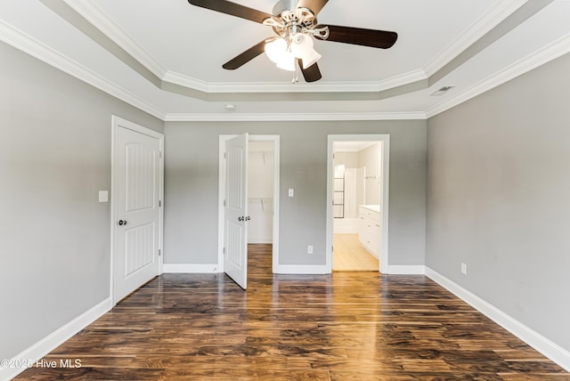 1711 Reidsville Rd, Southport, NC 28461 - unfurnished bedroom featuring a tray ceiling, wood finished floors, baseboards, ornamental molding, and ensuite bath