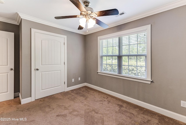 1711 Reidsville Rd, Southport, NC 28461 - unfurnished bedroom with carpet flooring, crown molding, baseboards, and a ceiling fan