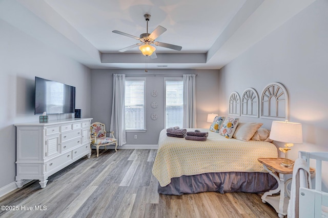 576 Steele Loop, Wilmington, NC 28411 - bedroom with wood finished floors, a raised ceiling, baseboards, and ceiling fan