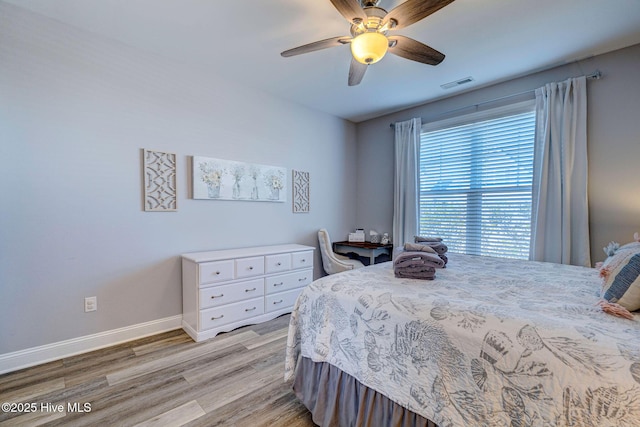 576 Steele Loop, Wilmington, NC 28411 - bedroom with light wood-style flooring, baseboards, and a ceiling fan
