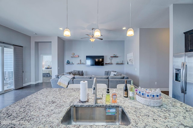 576 Steele Loop, Wilmington, NC 28411 - kitchen featuring a sink, stainless steel fridge, dark wood-style flooring, light stone counters, and recessed lighting