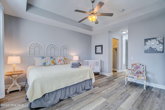 576 Steele Loop, Wilmington, NC 28411 - bedroom featuring a raised ceiling, wood finished floors, baseboards, and a ceiling fan