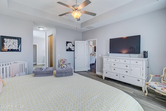 576 Steele Loop, Wilmington, NC 28411 - bedroom featuring wood finished floors, a raised ceiling, baseboards, and ceiling fan