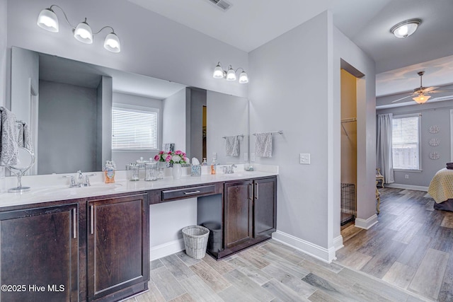 576 Steele Loop, Wilmington, NC 28411 - bathroom featuring a ceiling fan, double vanity, wood finished floors, and baseboards