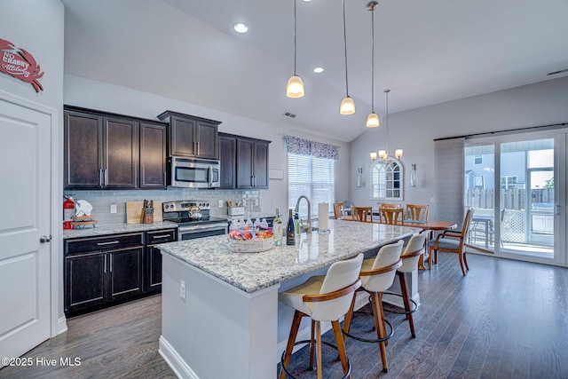 576 Steele Loop, Wilmington, NC 28411 - kitchen with appliances with stainless steel finishes, wood finished floors, lofted ceiling, a chandelier, and a breakfast bar