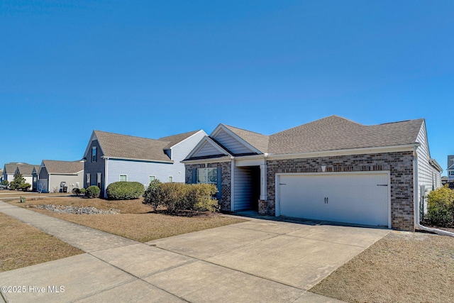 576 Steele Loop, Wilmington, NC 28411 - view of front of house featuring an attached garage, concrete driveway, and brick siding