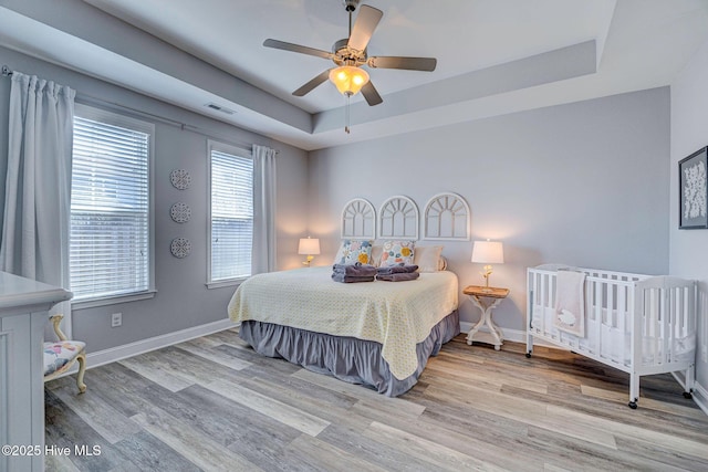 576 Steele Loop, Wilmington, NC 28411 - bedroom with a raised ceiling, wood finished floors, and baseboards