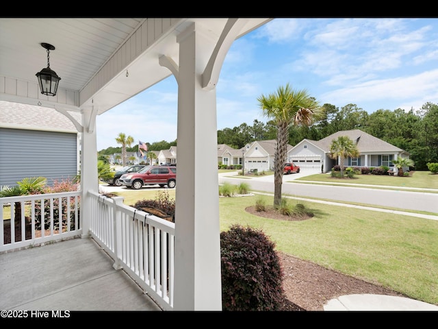 7024 Bonaventure St SW, Ocean Isle Beach, NC 28469 - porch with a residential view and a yard