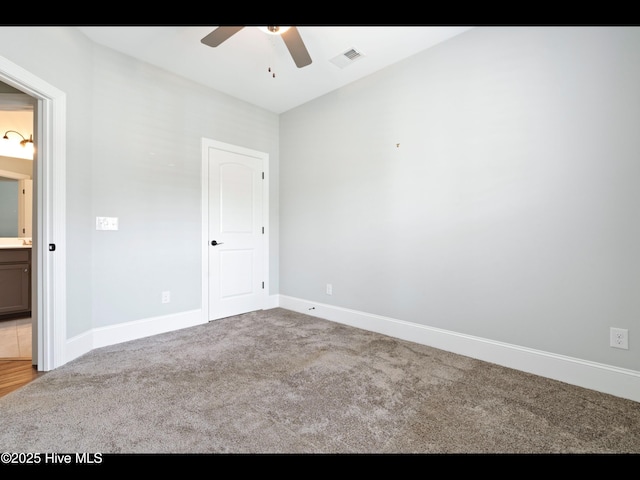 7024 Bonaventure St SW, Ocean Isle Beach, NC 28469 - unfurnished bedroom featuring carpet, baseboards, and ceiling fan