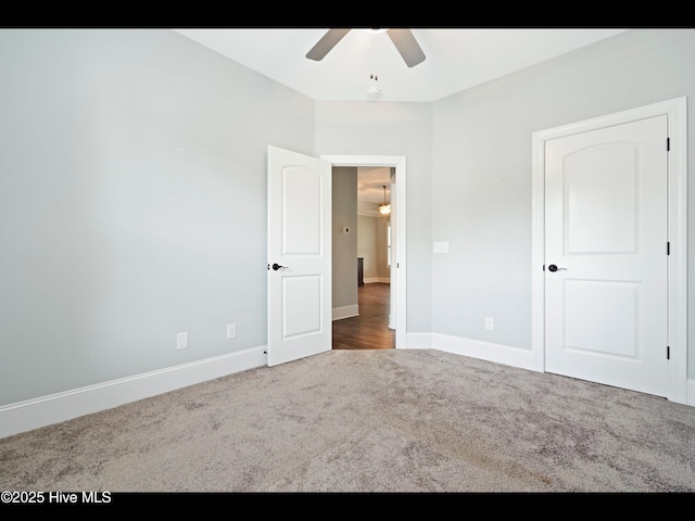 7024 Bonaventure St SW, Ocean Isle Beach, NC 28469 - unfurnished bedroom featuring carpet floors, baseboards, and ceiling fan