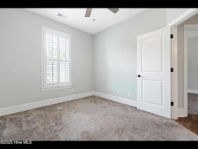 7024 Bonaventure St SW, Ocean Isle Beach, NC 28469 - spare room with a ceiling fan, carpet floors, and baseboards