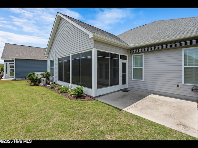 7024 Bonaventure St SW, Ocean Isle Beach, NC 28469 - rear view of property with a sunroom, a patio, a lawn, roof with shingles, and central air condition unit