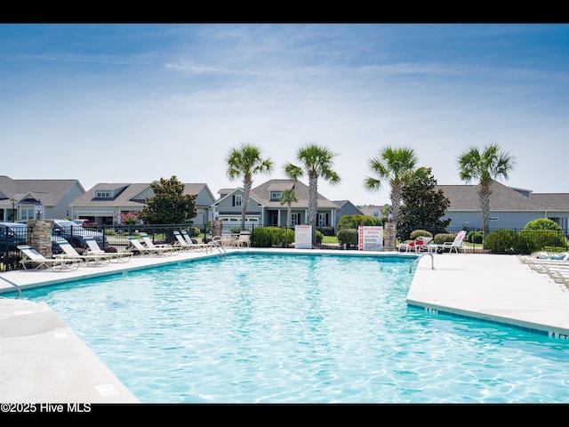 7024 Bonaventure St SW, Ocean Isle Beach, NC 28469 - community pool featuring a residential view and a patio area