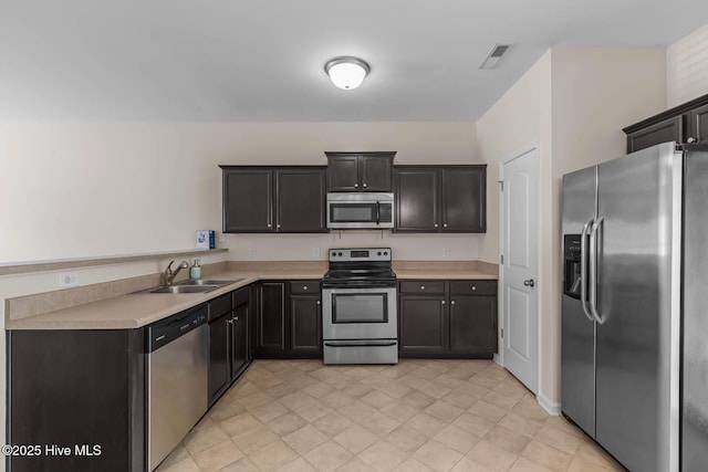 505 Oyster Rock Ln, Sneads Ferry, NC 28460 - kitchen featuring appliances with stainless steel finishes, a sink, light countertops, and light tile patterned floors