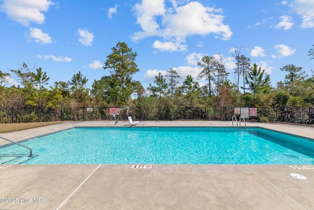 505 Oyster Rock Ln, Sneads Ferry, NC 28460 - community pool with view of scattered trees and a patio