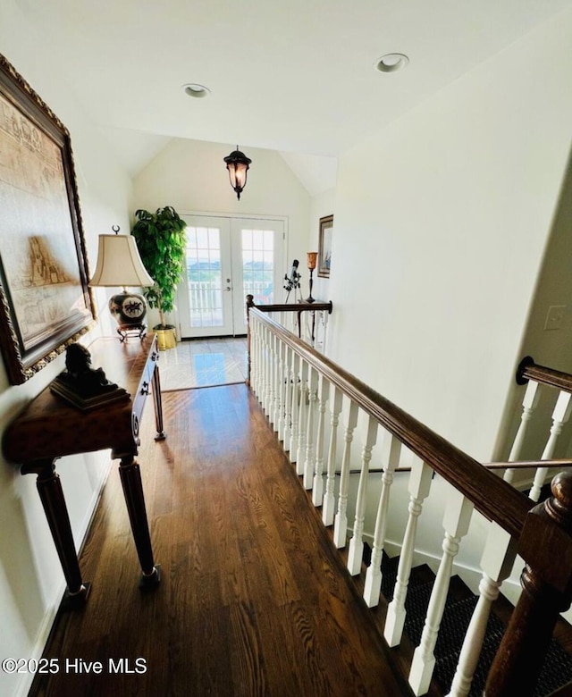 108 Kiawa Way, Atlantic Beach, NC 28512 - hallway featuring french doors, wood finished floors, vaulted ceiling, and an upstairs landing