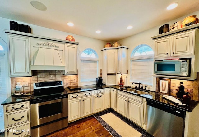 108 Kiawa Way, Atlantic Beach, NC 28512 - kitchen featuring appliances with stainless steel finishes, premium range hood, a sink, healthy amount of natural light, and recessed lighting