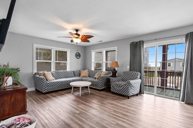 926 E Beach Dr, Oak Island, NC 28465 - living area featuring wood finished floors, a ceiling fan, and baseboards