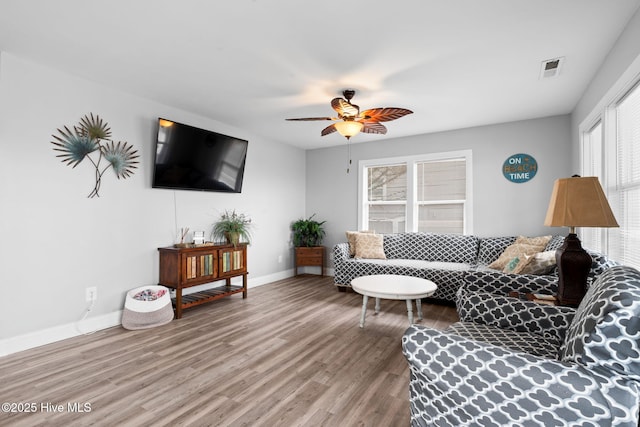 926 E Beach Dr, Oak Island, NC 28465 - living area with wood finished floors, baseboards, and a ceiling fan
