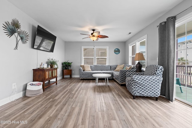 926 E Beach Dr, Oak Island, NC 28465 - living room with light wood-type flooring, a ceiling fan, and baseboards