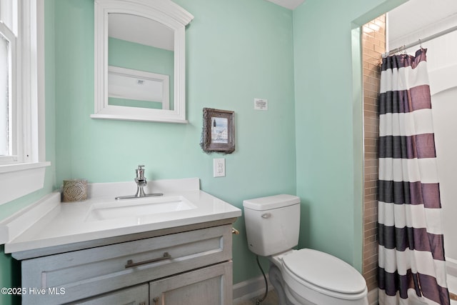 926 E Beach Dr, Oak Island, NC 28465 - bathroom featuring vanity, toilet, and curtained shower