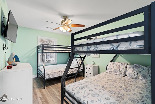 926 E Beach Dr, Oak Island, NC 28465 - bedroom with wood finished floors, baseboards, and a ceiling fan