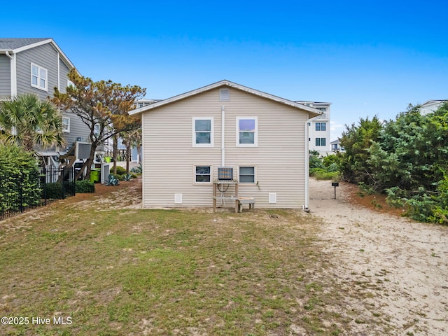 926 E Beach Dr, Oak Island, NC 28465 - back of house featuring a lawn