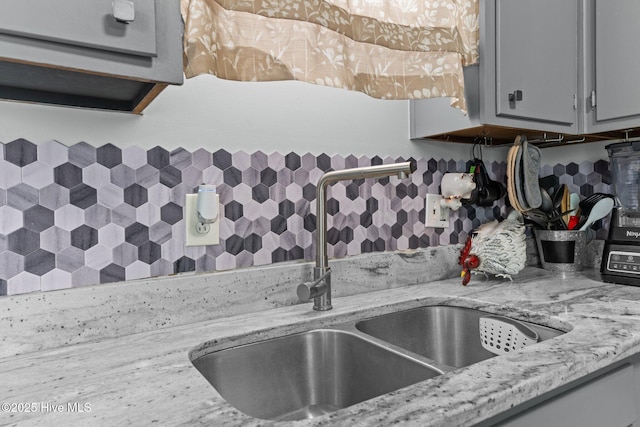 24 Donnell, Havelock, NC 28532 - kitchen view of a sink, gray cabinetry, tasteful backsplash, and light stone counters