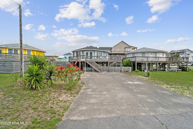 3045 Island Dr, North Topsail Beach, NC 28460 - view of front of home with stairs, a residential view, and a wooden deck